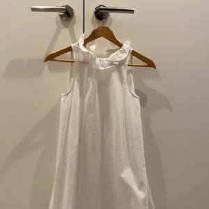 White sleeveless dress with ruffle neck